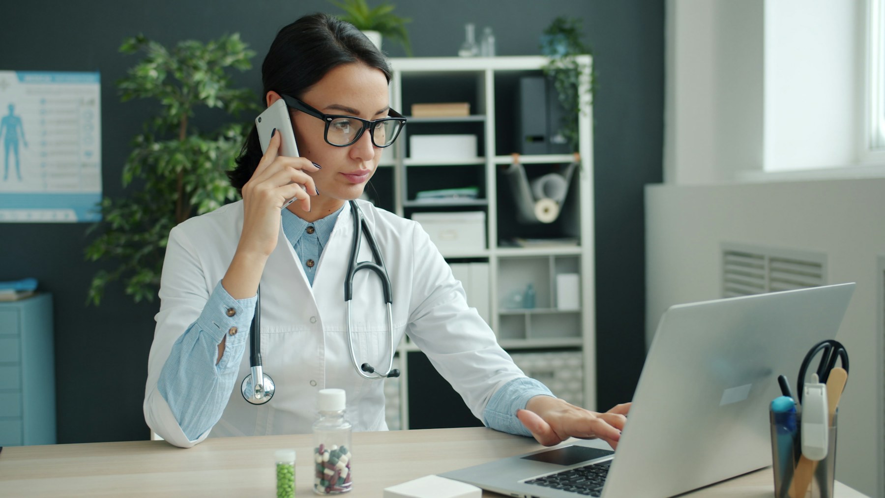 Clinician working at a laptop in a healthcare office